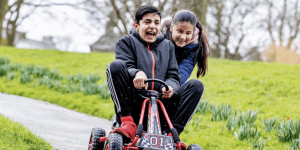 Two young people ride a go-kart